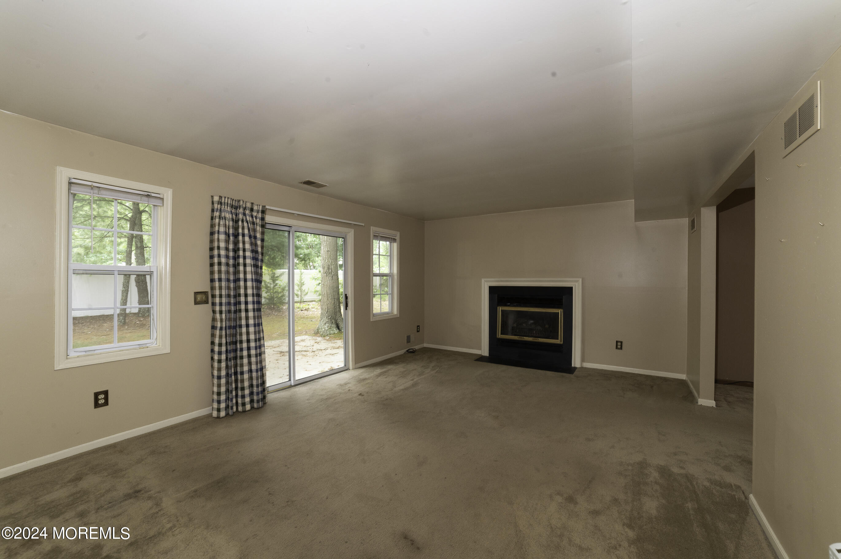 179 Wells Mill Road Waretown, NJ 08758 - Photo 9 of 28 a view of empty room with windows