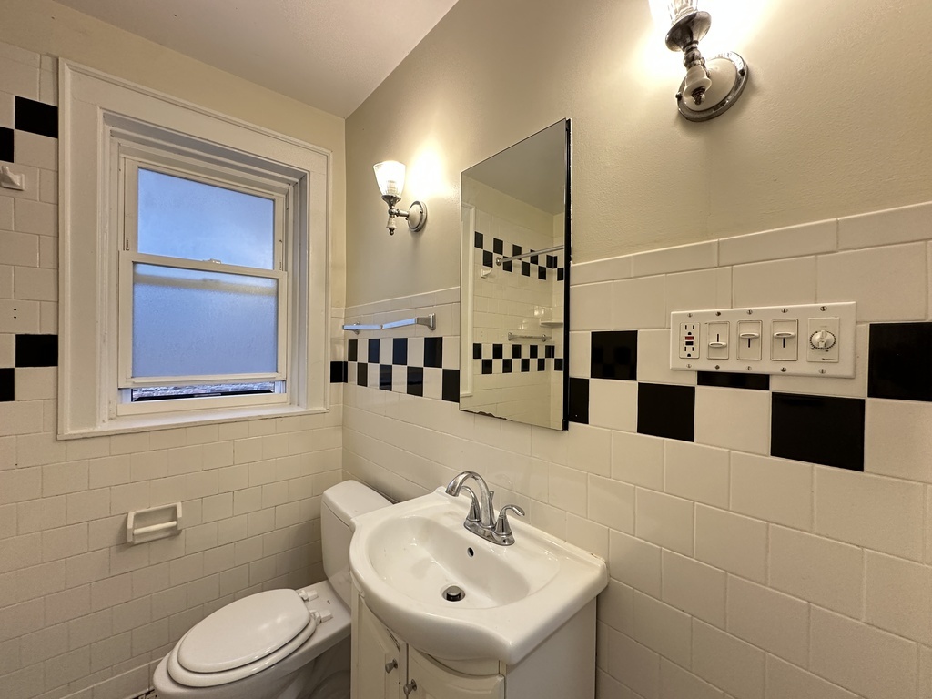 2619 West Greenleaf Avenue, Unit 2 Chicago, IL 60645 - Photo 20 of 22 a bathroom with a toilet sink and mirror