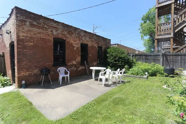 a view of a patio with table and chairs and potted plants