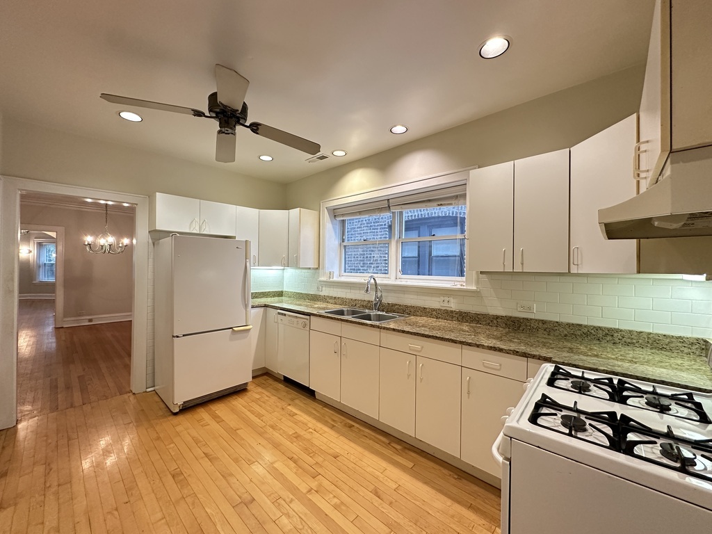 2619 West Greenleaf Avenue, Unit 2 Chicago, IL 60645 - Photo 3 of 22 a kitchen with refrigerator and cabinets