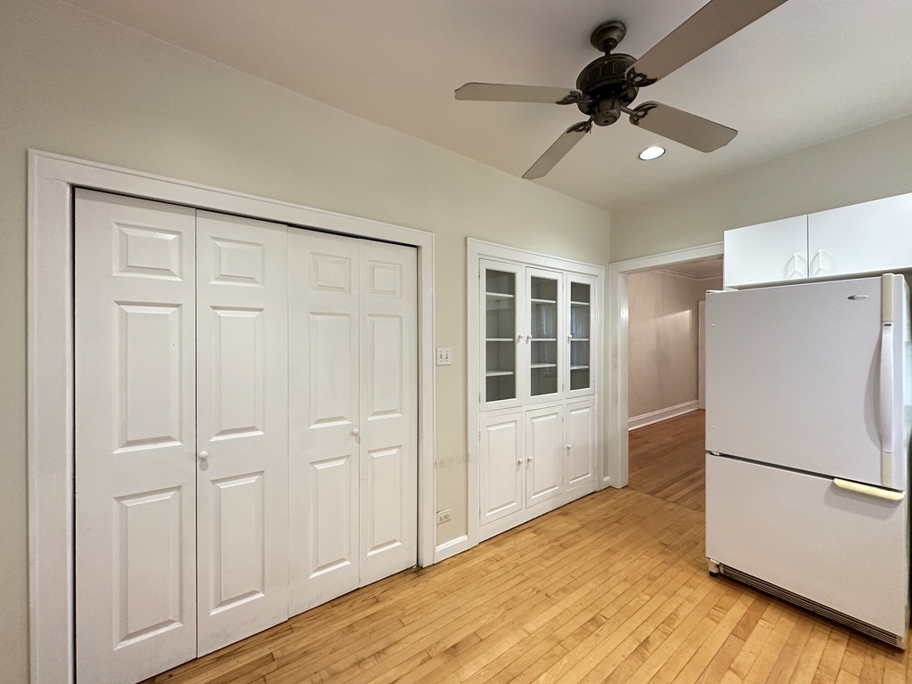 2619 West Greenleaf Avenue, Unit 2 Chicago, IL 60645 - Photo 5 of 22 a view of a kitchen with a refrigerator a ceiling fan and wooden floor