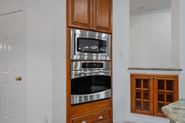a kitchen with stainless steel appliances granite countertop a stove and a microwave