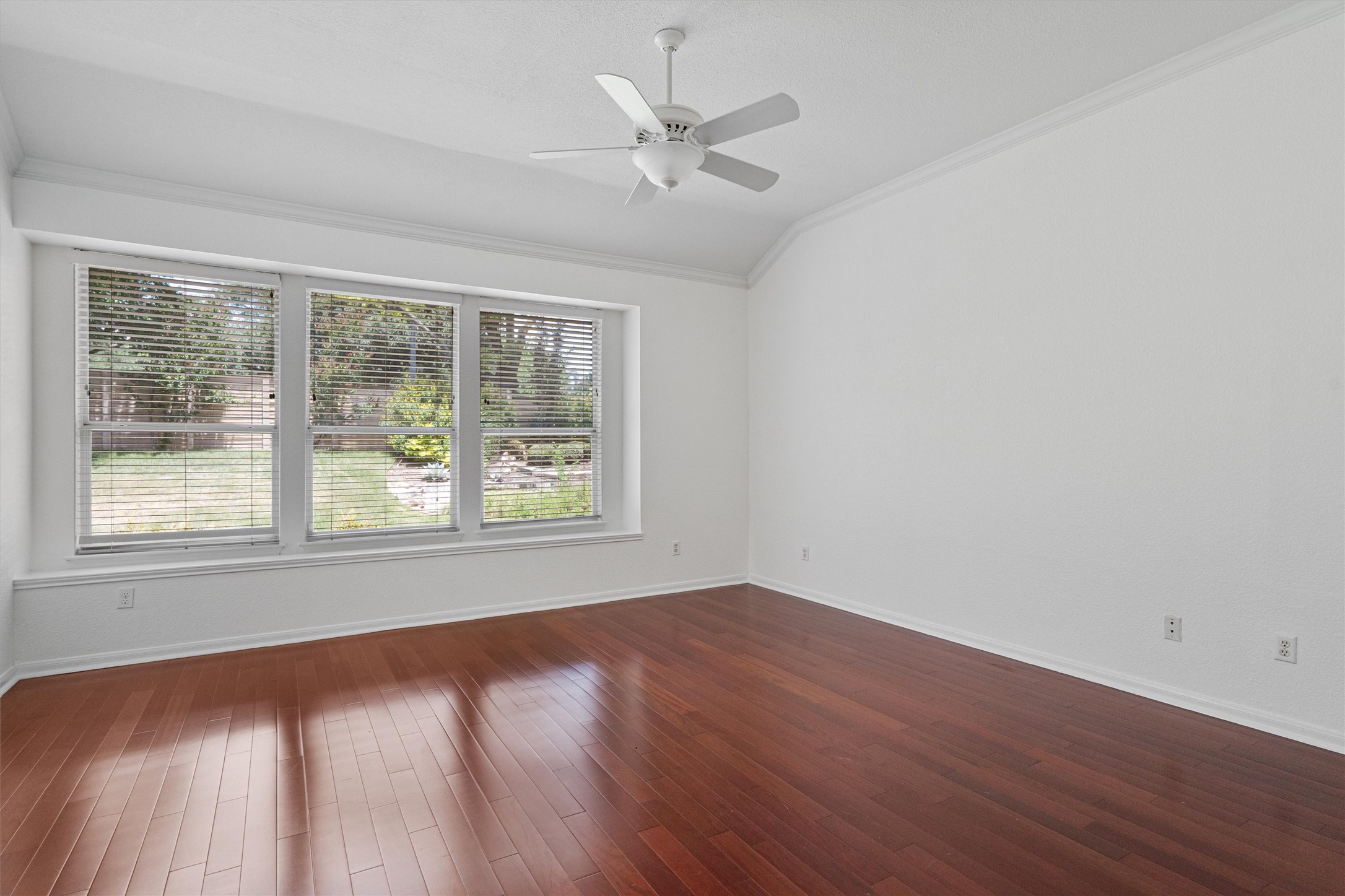 2328 Rodeo Drive Austin, TX 78727 - Photo 21 of 40 a view of an empty room with wooden floor and a window