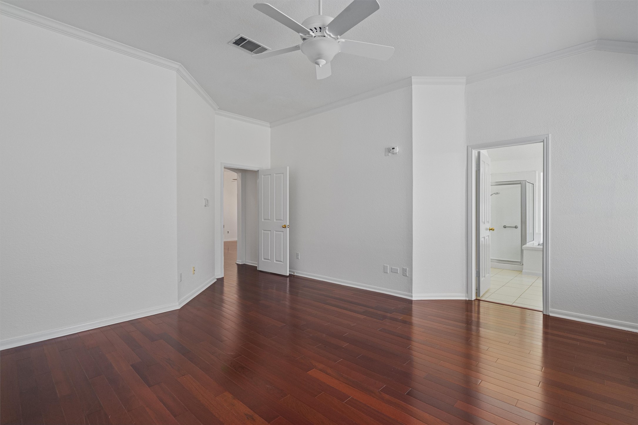 2328 Rodeo Drive Austin, TX 78727 - Photo 22 of 40 an empty room with wooden floor and a ceiling fan