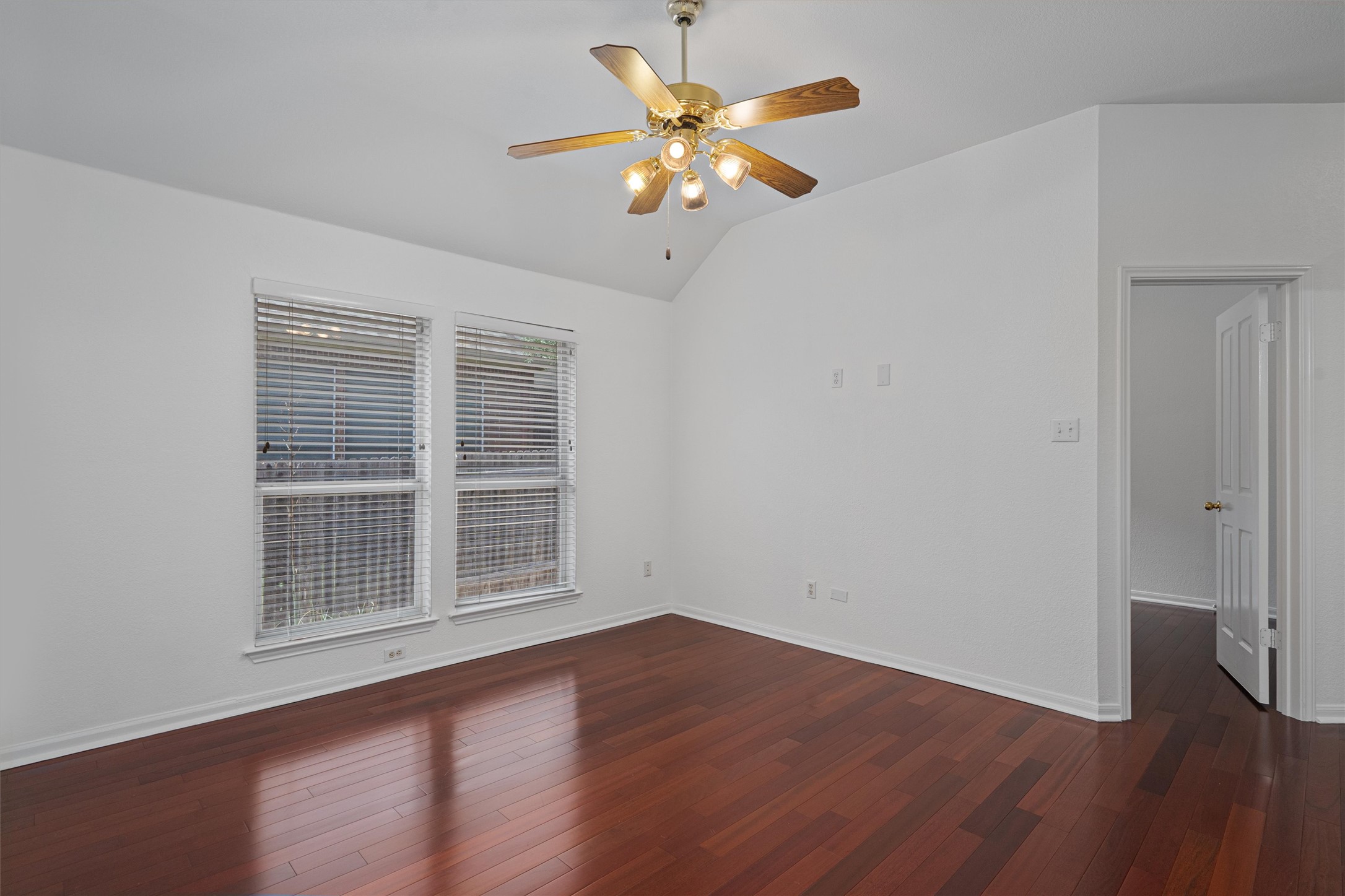 2328 Rodeo Drive Austin, TX 78727 - Photo 25 of 40 a view of an empty room with wooden floor and a ceiling fan