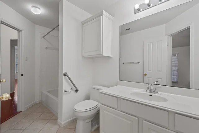 a bathroom with a sink a toilet and a shower