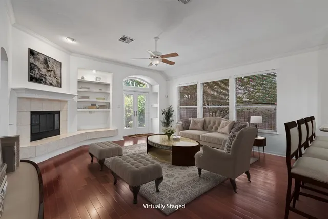 a living room with fireplace furniture and a large window