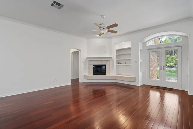 wooden floor in an empty room with a window