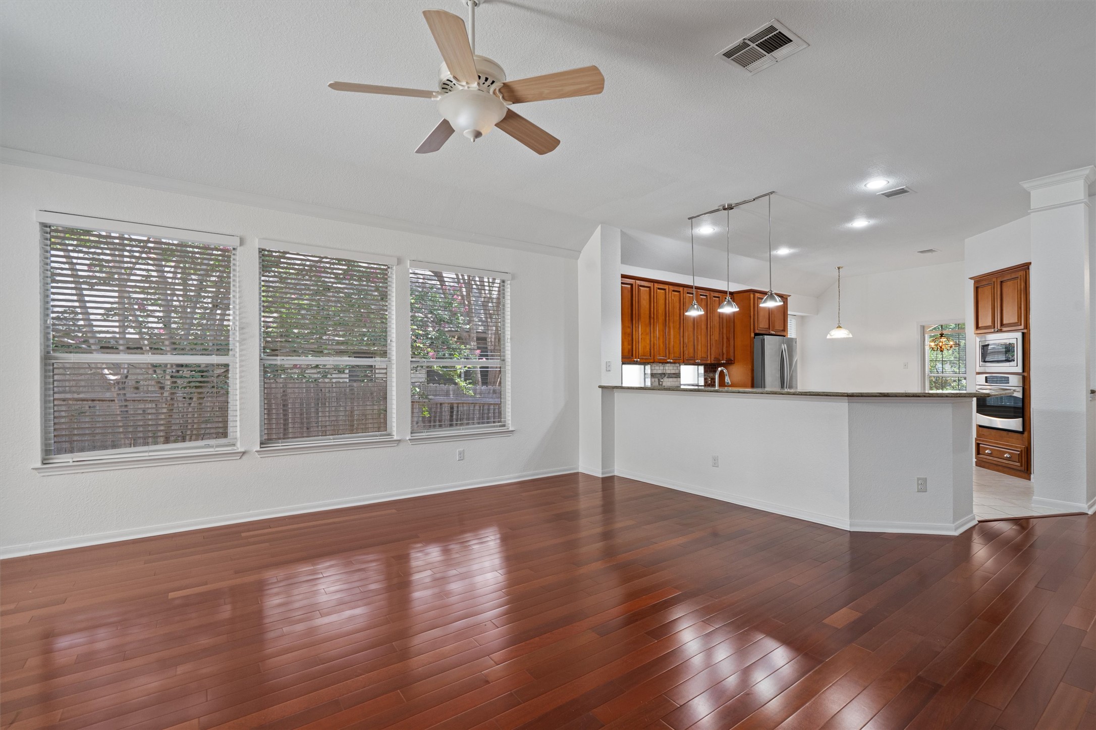 2328 Rodeo Drive Austin, TX 78727 - Photo 8 of 40 a view of an empty room with wooden floor and a window