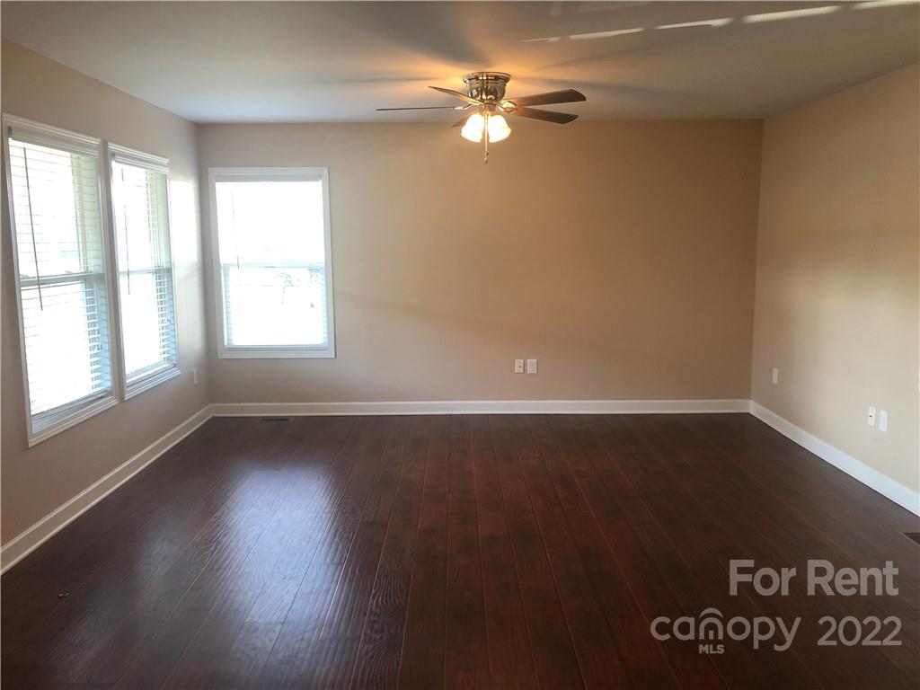 1401 Hickory Grove Road Gastonia, NC 28056 - Photo 2 of 12 an empty room with wooden floor and windows