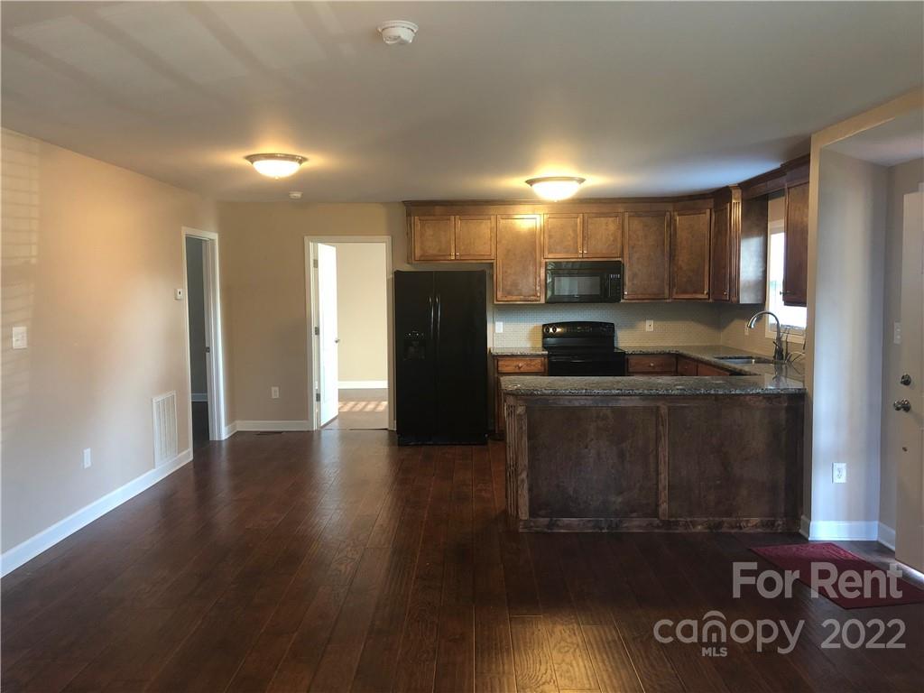 1401 Hickory Grove Road Gastonia, NC 28056 - Photo 3 of 12 a kitchen with a refrigerator and a stove top oven