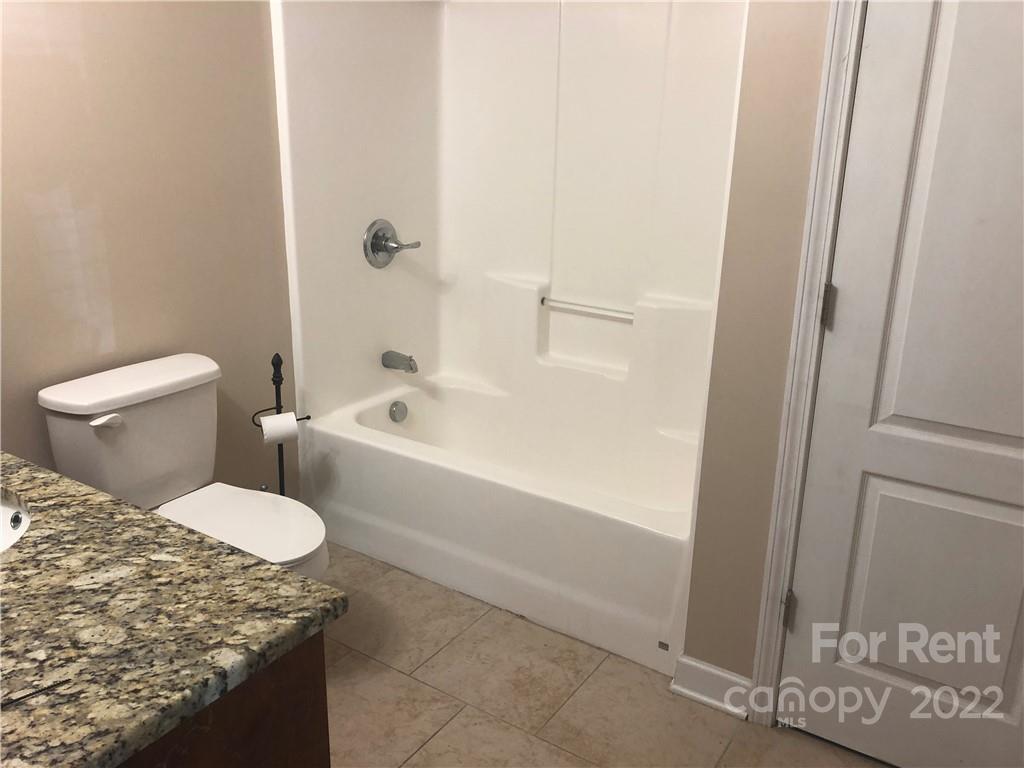 1401 Hickory Grove Road Gastonia, NC 28056 - Photo 8 of 12 a bathroom with a granite countertop sink and toilet