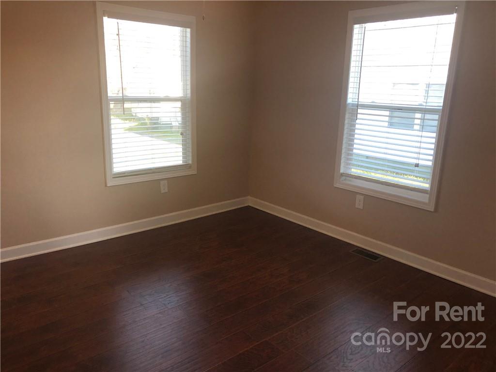 1401 Hickory Grove Road Gastonia, NC 28056 - Photo 9 of 12 an empty room with wooden floor and windows