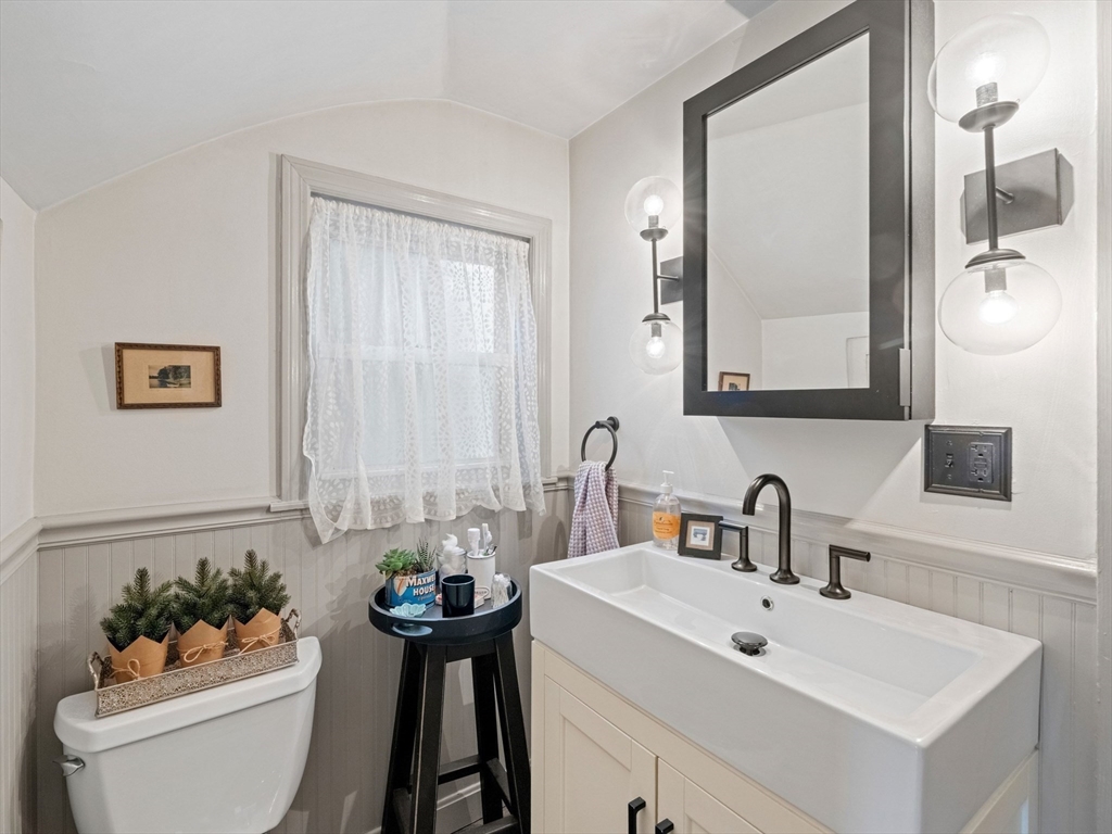 5 Holten Street Danvers, MA 01923 - Photo 20 of 42 a bathroom with a toilet a sink and mirror
