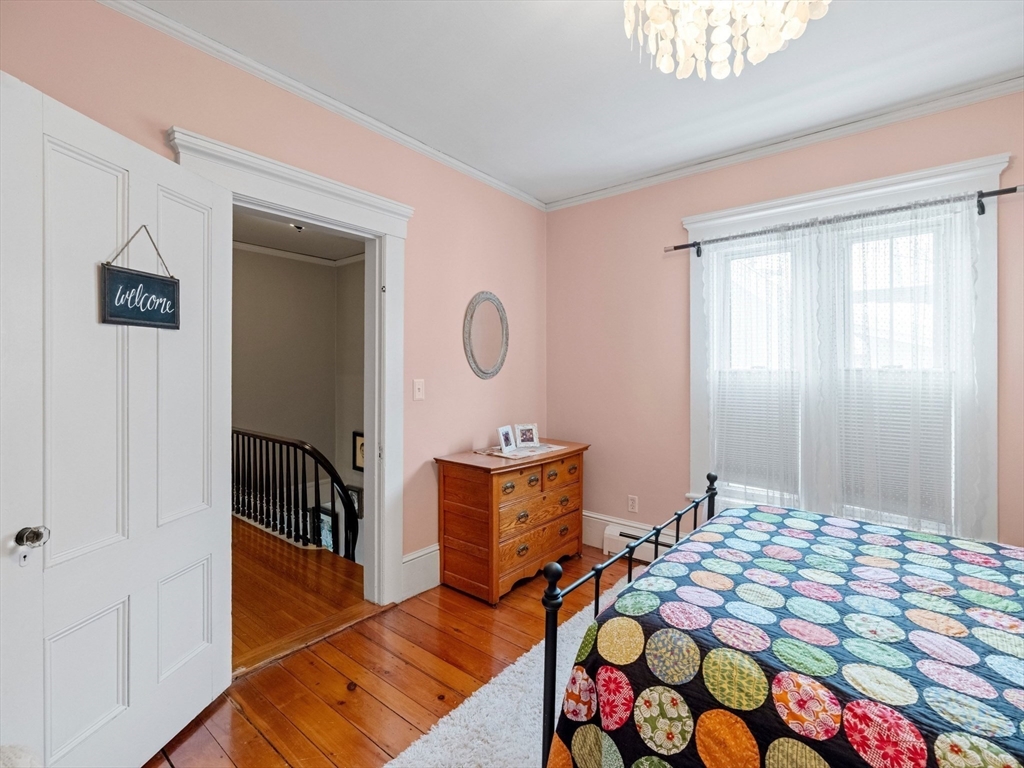 5 Holten Street Danvers, MA 01923 - Photo 24 of 42 a bedroom with a bed and wooden floor