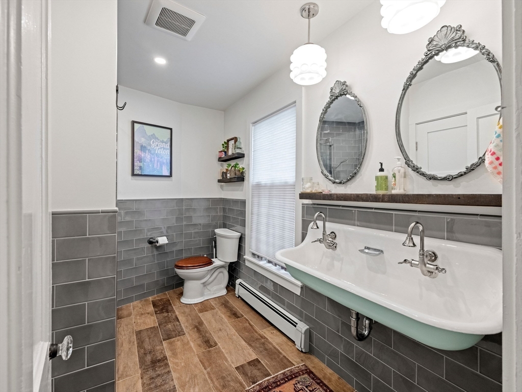 5 Holten Street Danvers, MA 01923 - Photo 28 of 42 a bathroom with a sink mirror and vanity