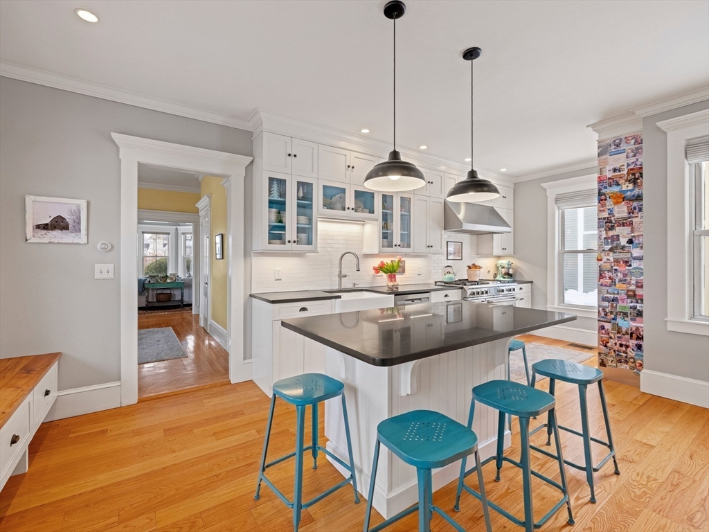 5 Holten Street Danvers, MA 01923 - Photo 4 of 42 a kitchen with stainless steel appliances kitchen island granite countertop a table and chairs