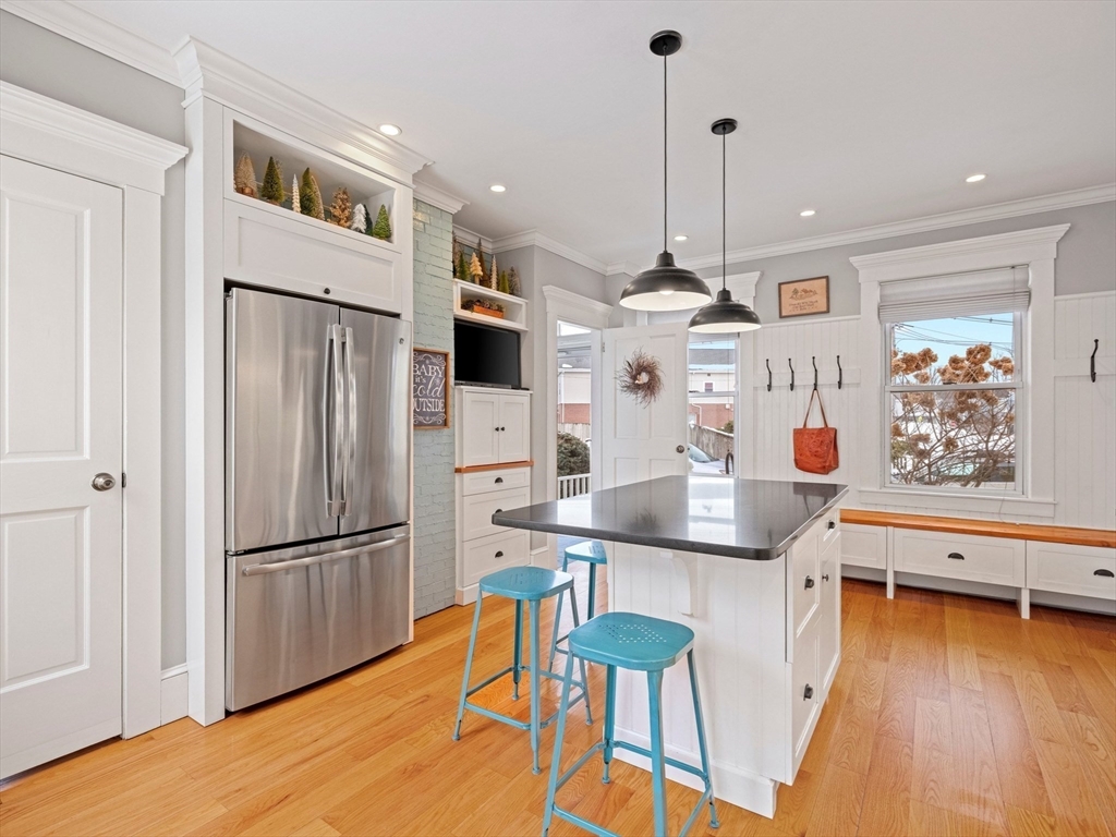 5 Holten Street Danvers, MA 01923 - Photo 8 of 42 a kitchen with stainless steel appliances granite countertop a refrigerator a stove and a wooden floors