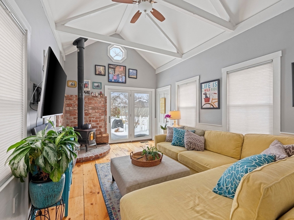5 Holten Street Danvers, MA 01923 - Photo 9 of 42 a living room with furniture a flat screen tv and a large window
