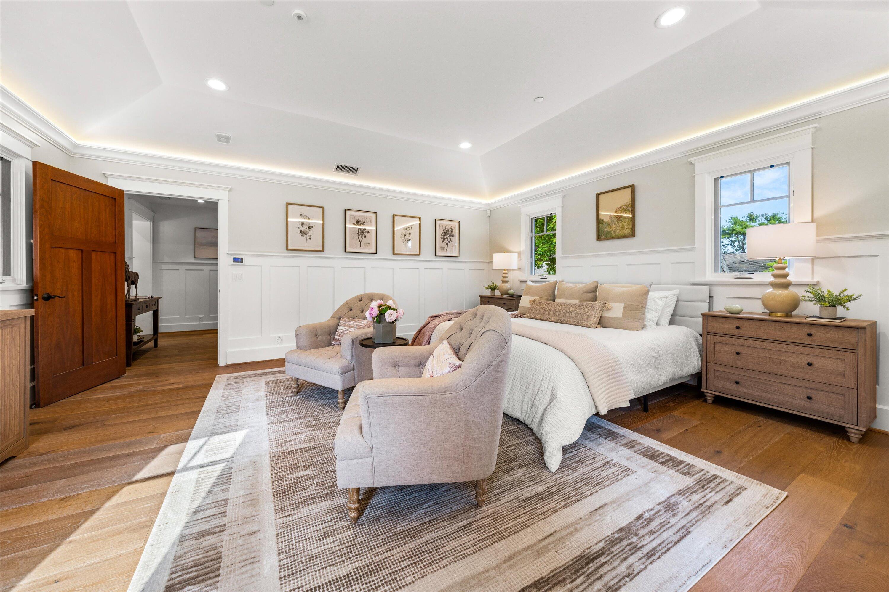 155 Santa Isabel Lane Montecito, CA 93108 - Photo 14 of 37 a spacious bedroom with a bed and wooden floor