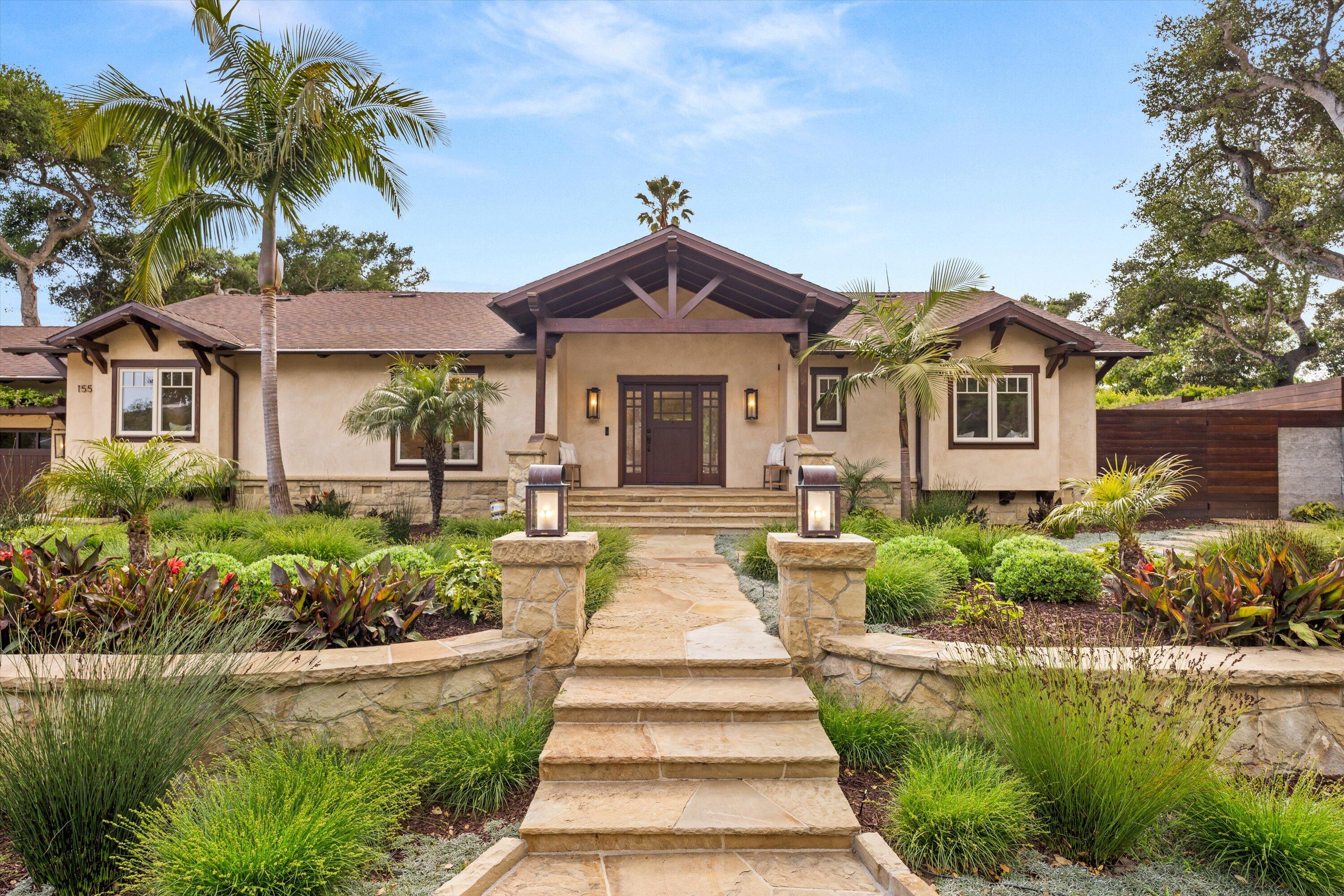155 Santa Isabel Lane Montecito, CA 93108 - Photo 2 of 37 a front view of a house with a yard and potted plants