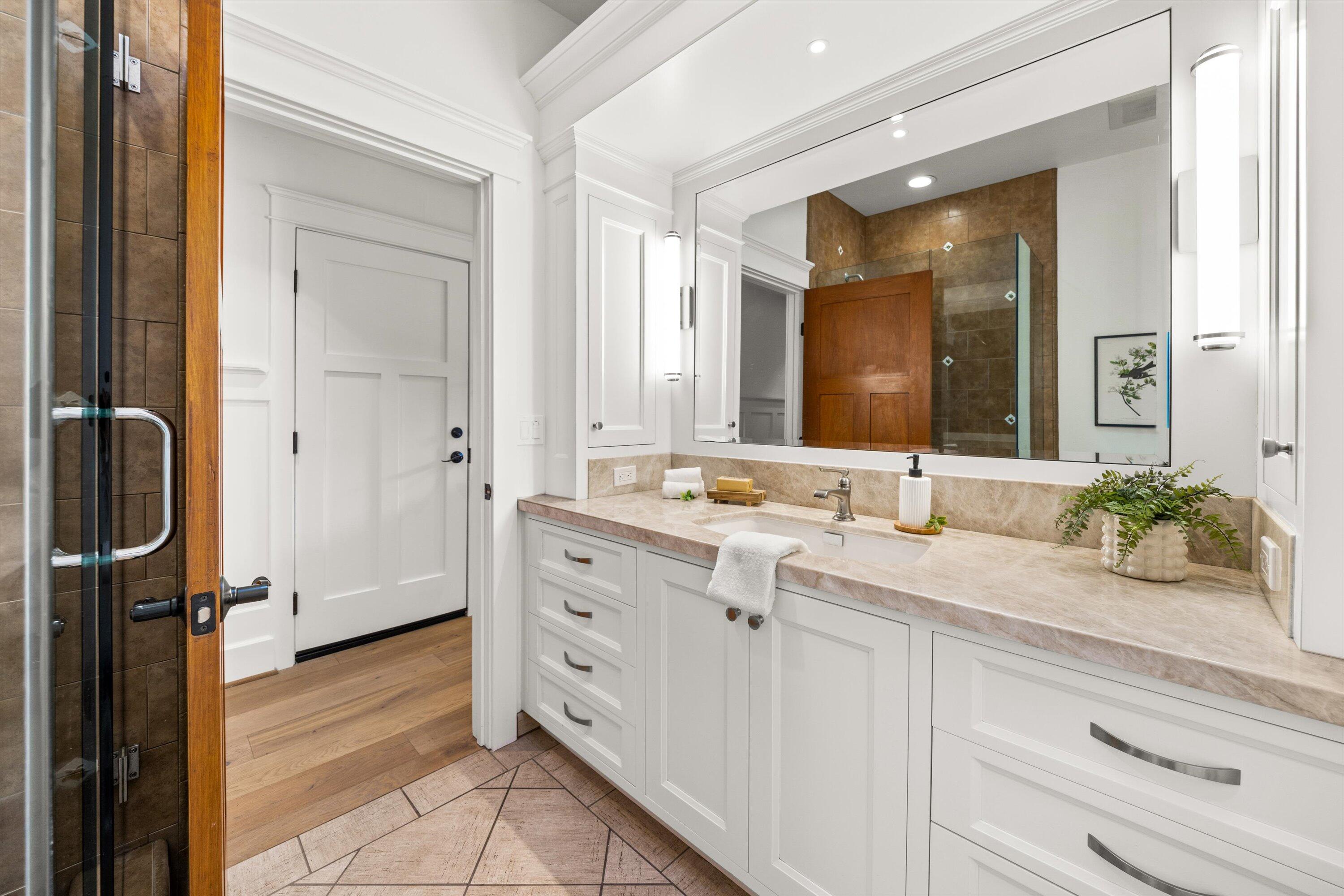 155 Santa Isabel Lane Montecito, CA 93108 - Photo 23 of 37 a spacious bathroom with a granite countertop sink and a mirror