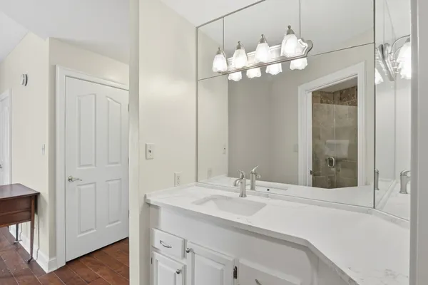 a bathroom with a sink vanity and mirror