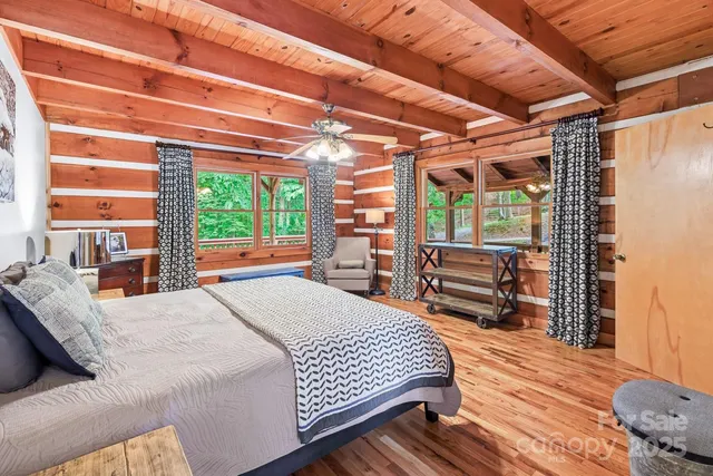 a bedroom with a bed next to a window