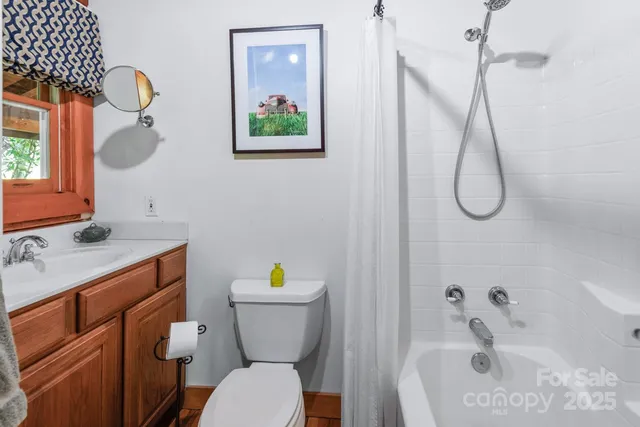 a bathroom with a sink mirror vanity and toilet
