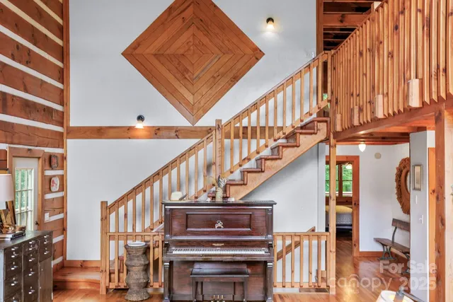 a view of entryway and hall with wooden floor