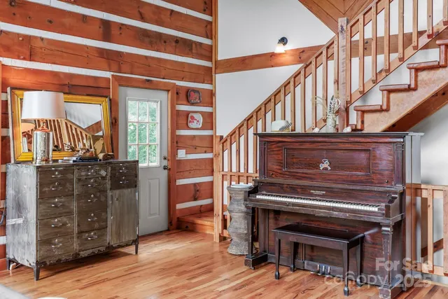 a view of entryway and hall with wooden floor
