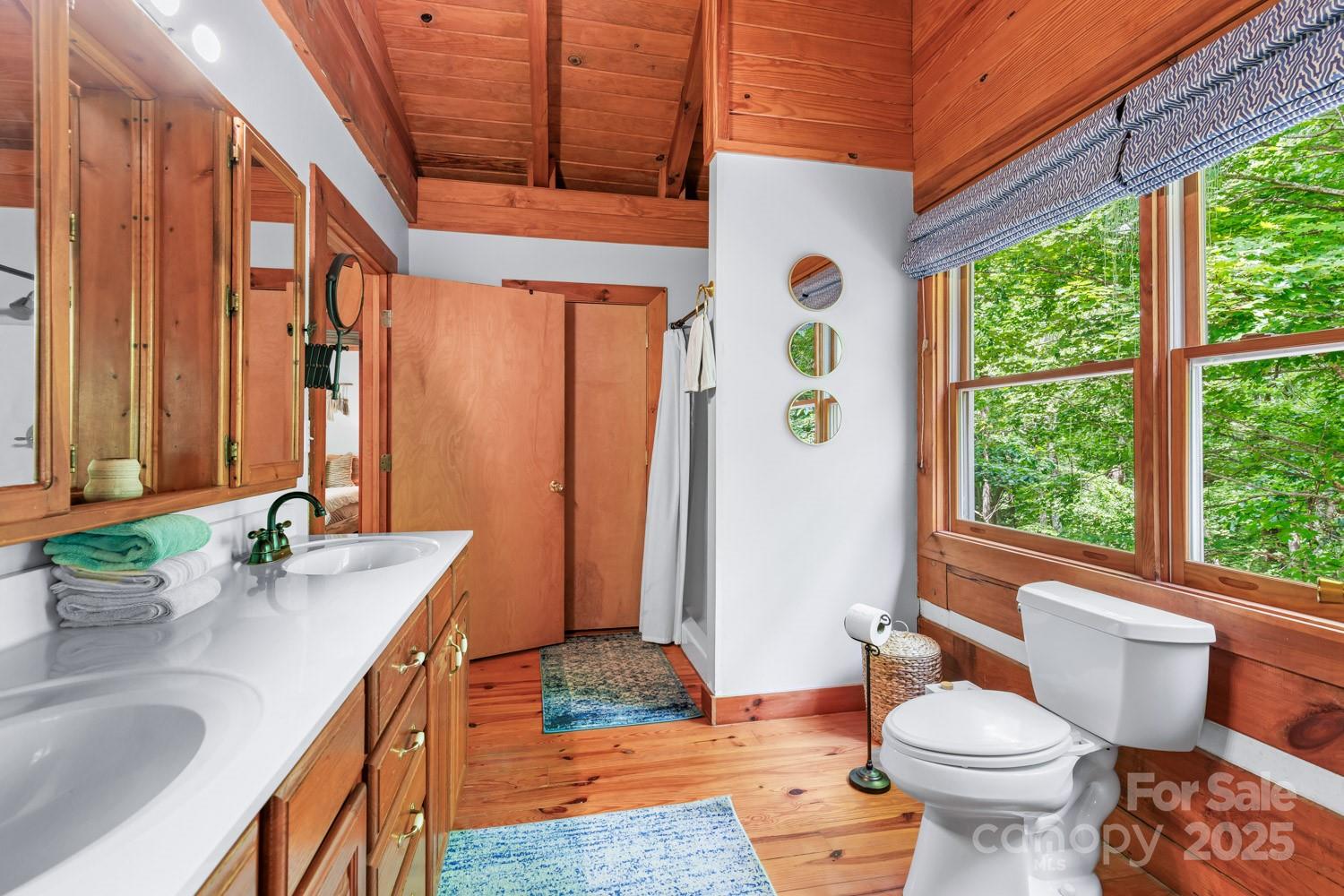 1745 Sugar Camp Road Marshall, NC 28753 - Photo 20 of 41 a bathroom with a granite countertop sink toilet and large windows