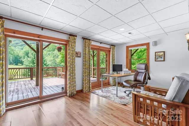 a view of a work space with wooden floor and furniture