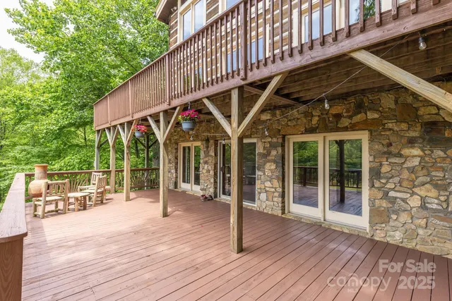 a patio with table and chairs and wooden floor