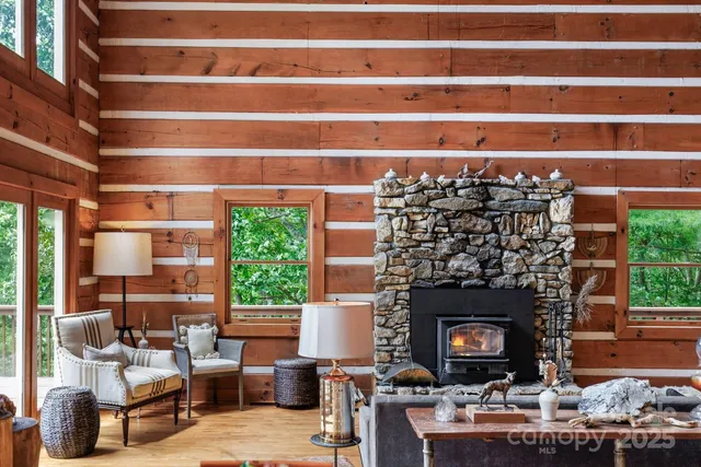 a living room with a fireplace and a floor to ceiling window