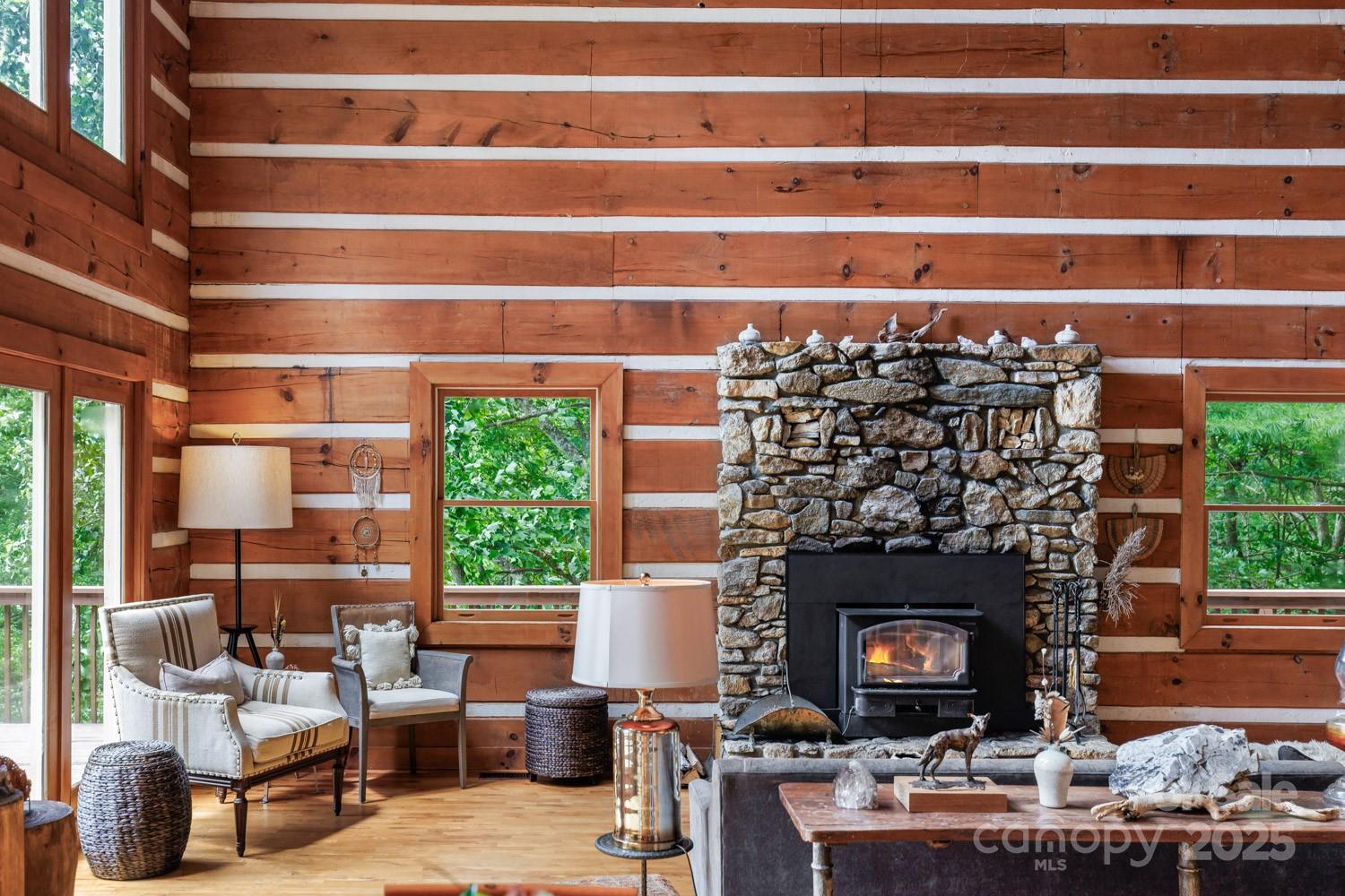 1745 Sugar Camp Road Marshall, NC 28753 - Photo 4 of 41 a living room with a fireplace and a floor to ceiling window