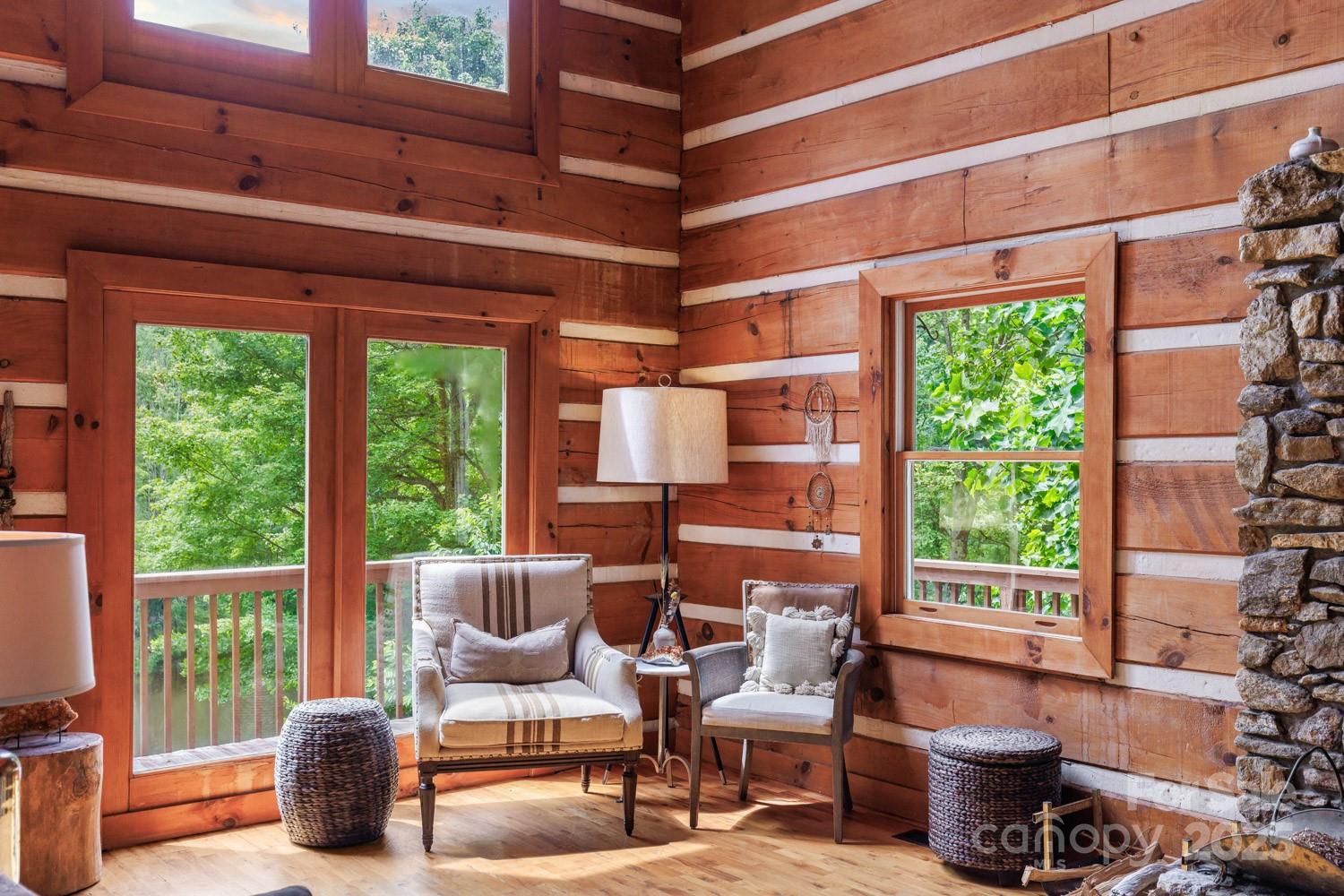 1745 Sugar Camp Road Marshall, NC 28753 - Photo 5 of 41 a living room with furniture and a floor to ceiling window