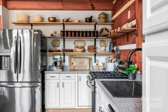 a kitchen with stainless steel appliances granite countertop a stove and a refrigerator