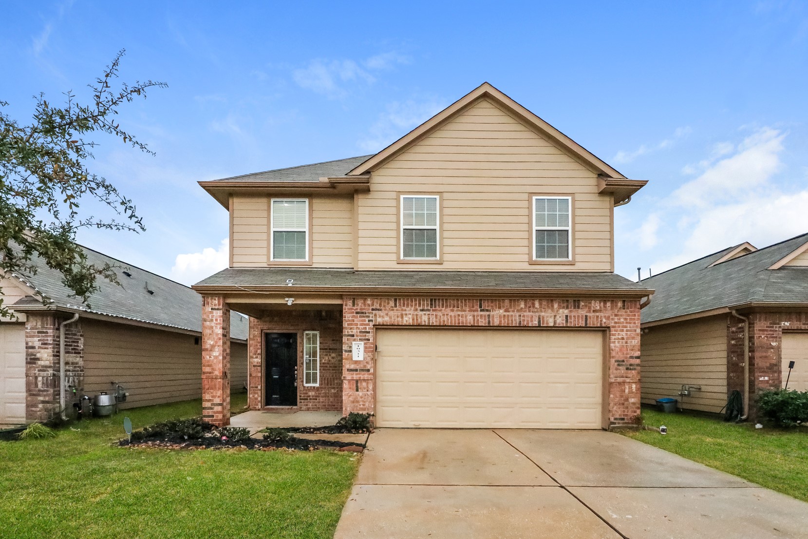 10311 Urban Oak Trail Houston, TX 77044 - Photo 1 of 15 a front view of a house with a yard and garage
