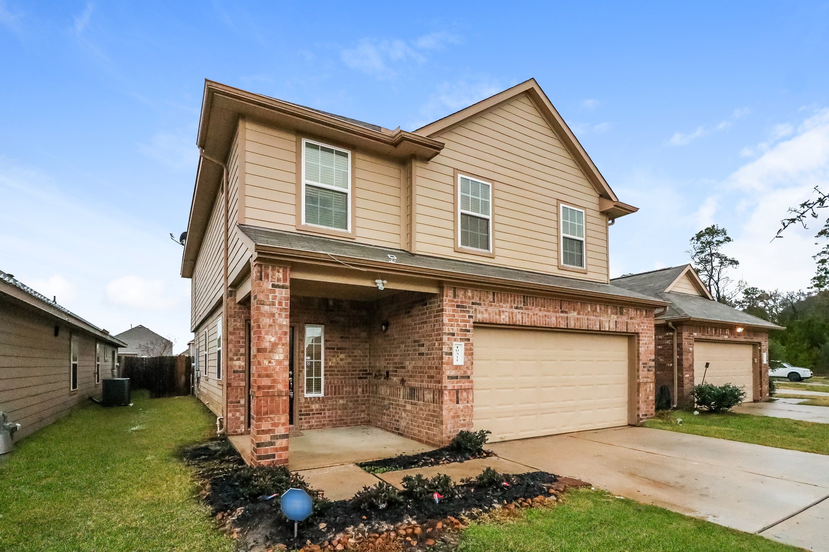 10311 Urban Oak Trail Houston, TX 77044 - Photo 2 of 15 a front view of a house with a yard and garage