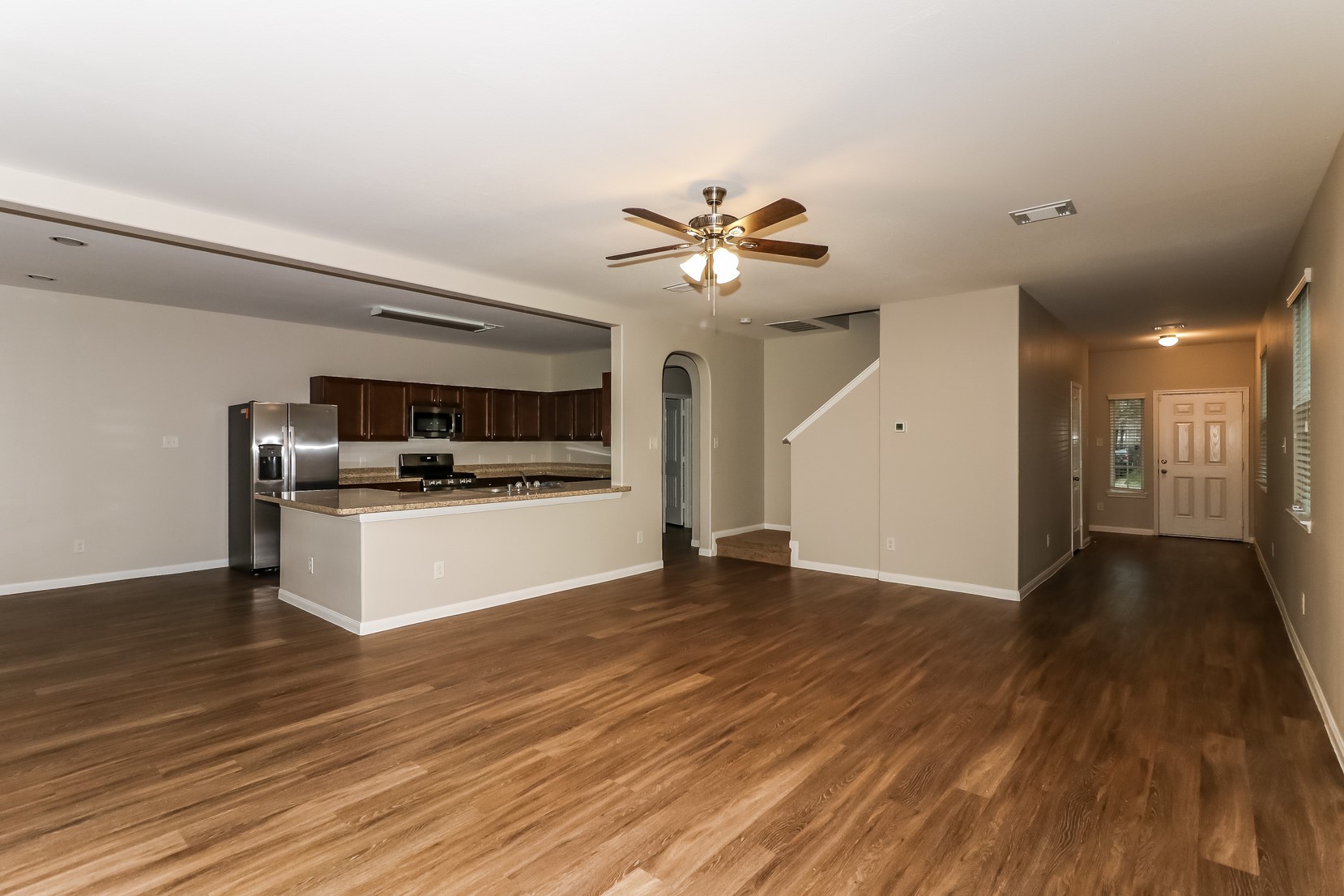 10311 Urban Oak Trail Houston, TX 77044 - Photo 3 of 15 a view of a kitchen with a sink and a stove top oven