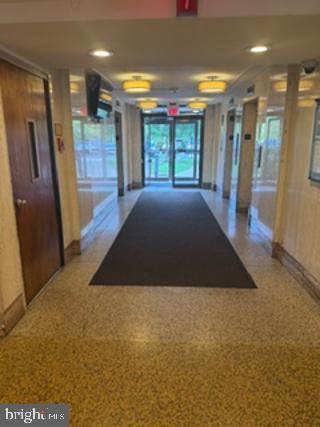 1121 University Boulevard West, Unit 1312 Silver Spring, MD 20902 - Photo 2 of 17 Inviting corridor with natural light.
