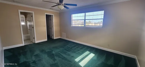 a view of room with window and ceiling fan