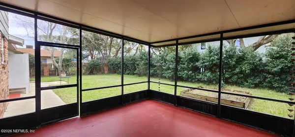 a view of a house with backyard and a tree