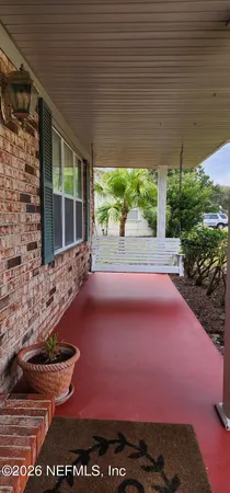 a backyard of a house with a yard and outdoor seating