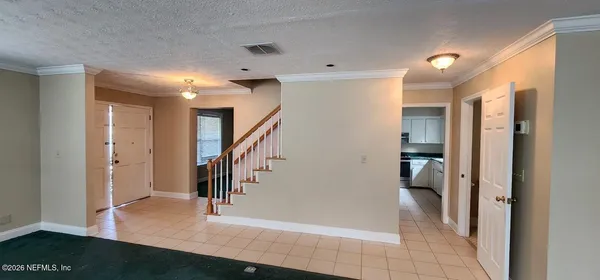 a view of entryway with furniture and wooden floor