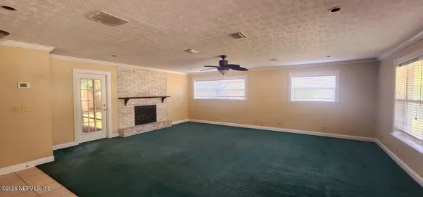 a view of empty room with a fireplace