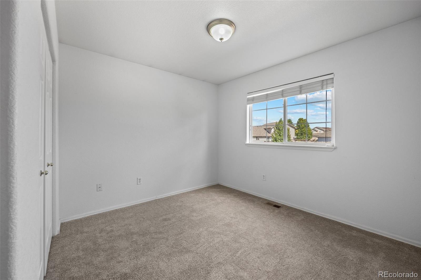 5328 Rustic Avenue Firestone, CO 80504 - Photo 11 of 22 an empty room with windows