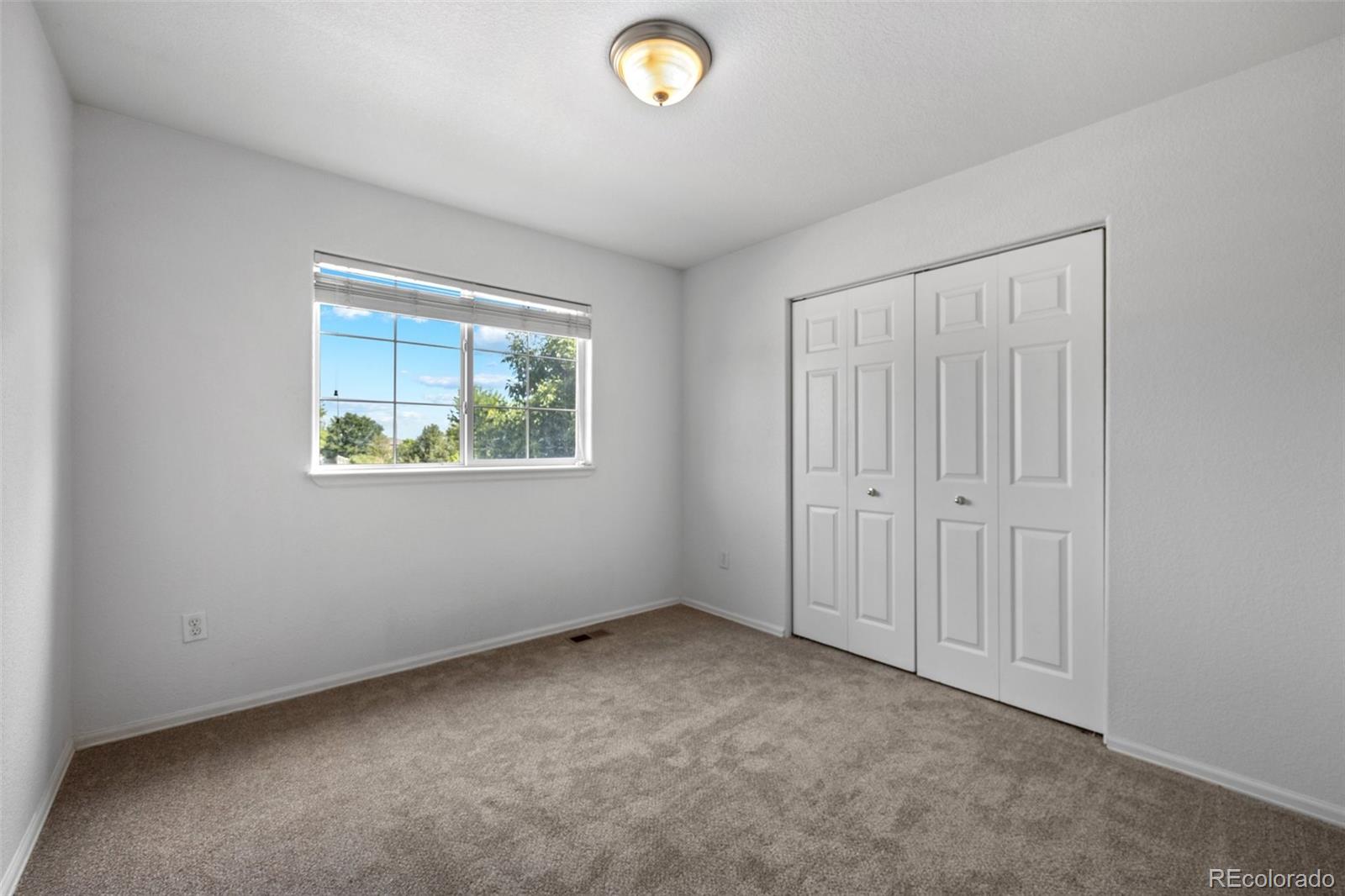 5328 Rustic Avenue Firestone, CO 80504 - Photo 12 of 22 an empty room with windows and closet