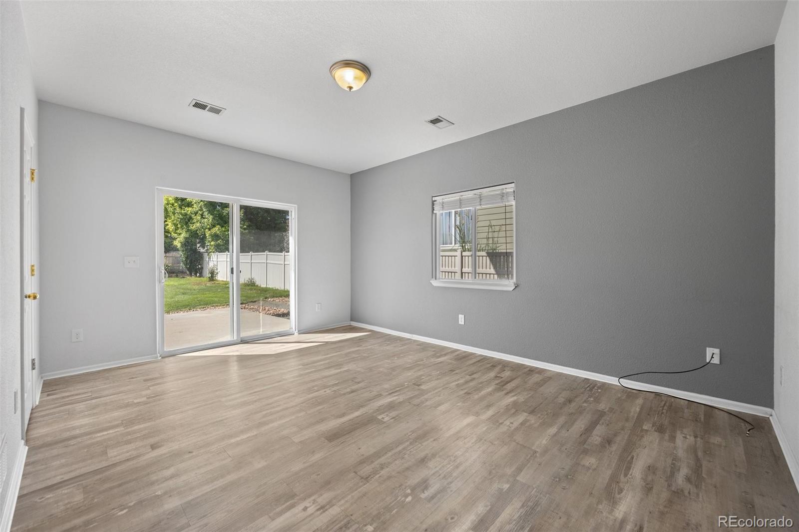 5328 Rustic Avenue Firestone, CO 80504 - Photo 14 of 22 wooden floor in an empty room with a window